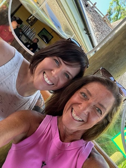 Lisa and Terina smiling together at a restaurant